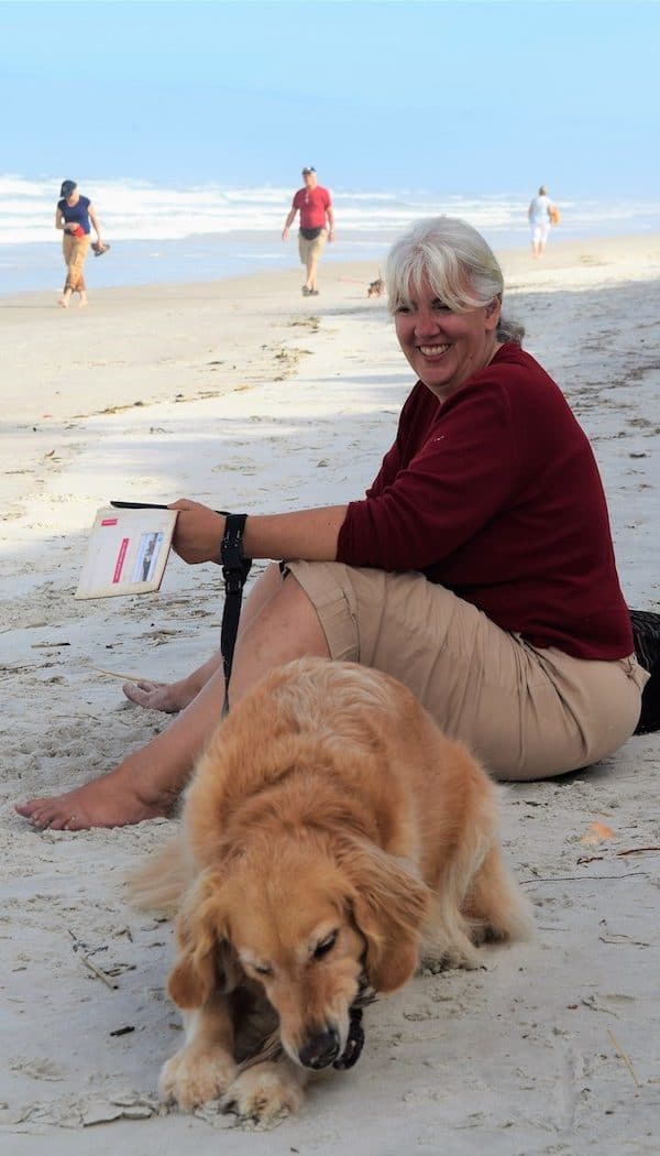 Honey the golden retriever and Pam wait on the beach at Fort Matanzas.