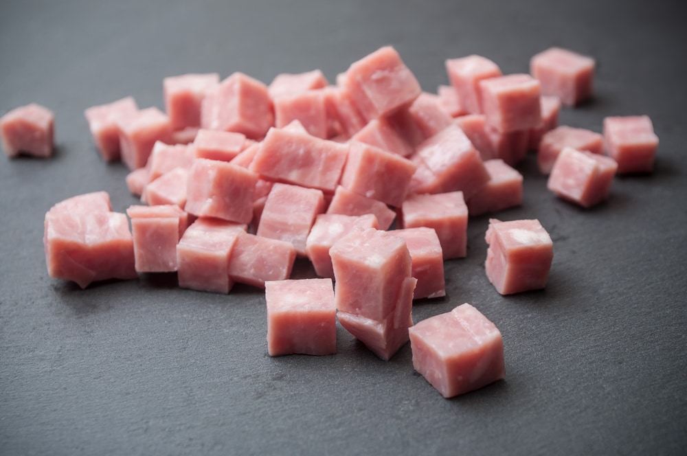 ham pieces cut up on a wodden cutting board pork meat