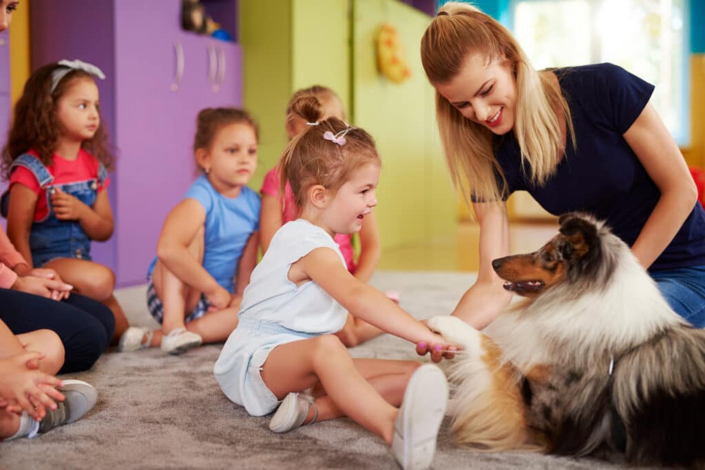 Happy Child Playing With Dog At School