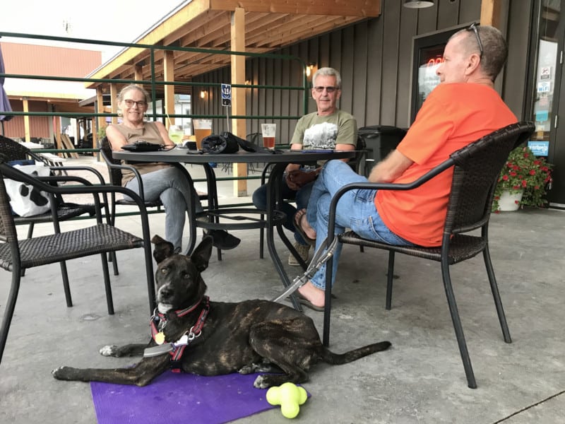 Woman and two men on the pet friendly porch at Custer Beacon in Custer, SD