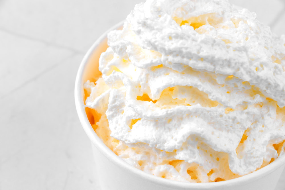 Bowl of whipped cream with ice cream