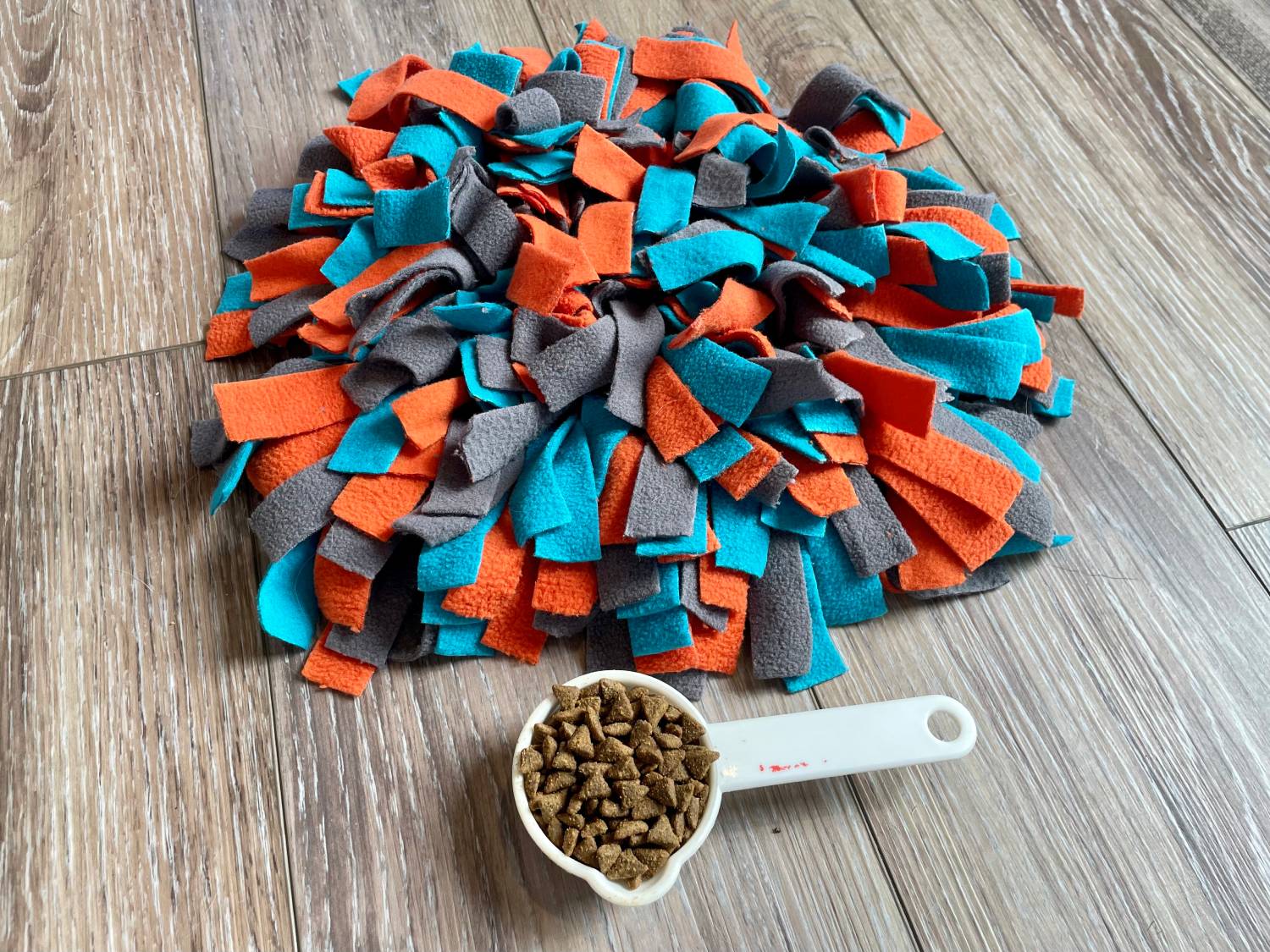 Messy Mutts Round Forage Mat Review - scoop of kibble beside the mat